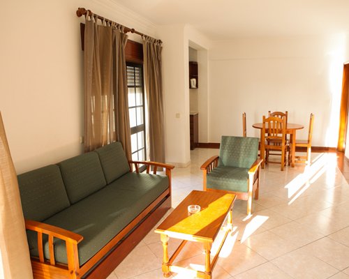 A well furnished bedroom with two beds television and an outside view.