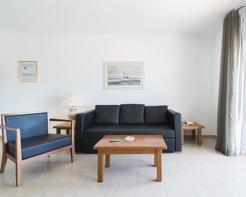 A well furnished bedroom with two twin beds and an outside view.