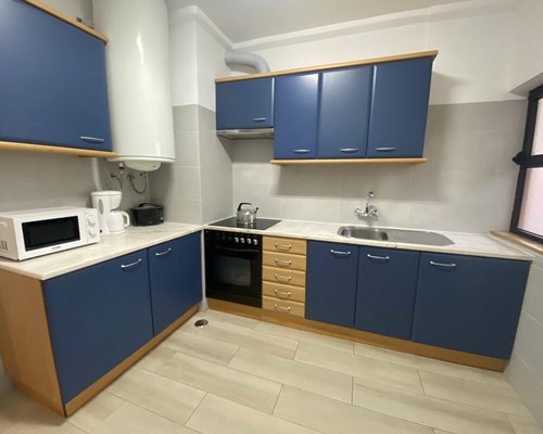 A well furnished bedroom with two beds and a balcony view.