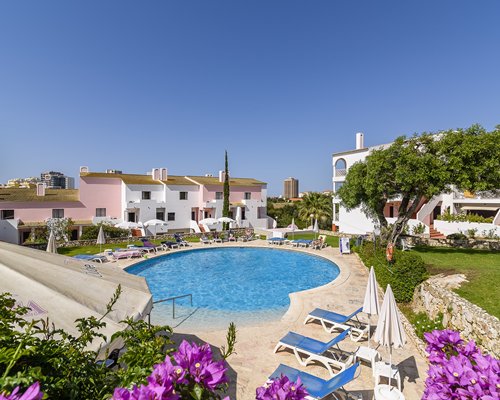 An outdoor swimming pool alongside the Clube Vilarosa resort.