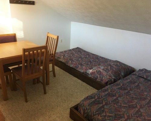 A WELL FURNISHED BEDROOM WITH DINING AREA.