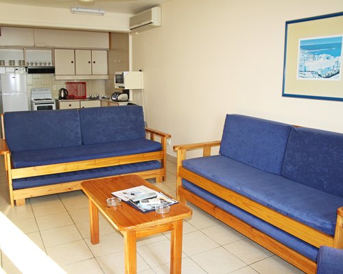 A well furnished living room with open plan kitchen.