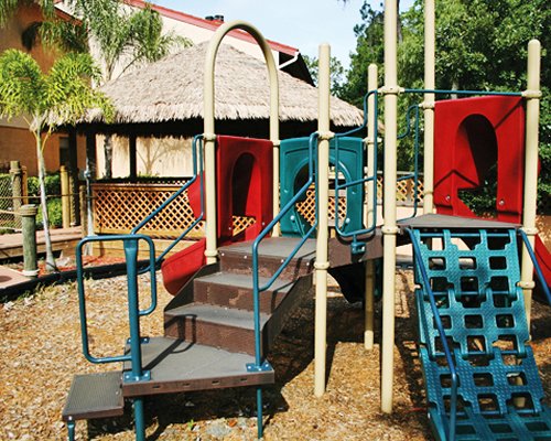 An outdoor kids playscape alongside resort unit.