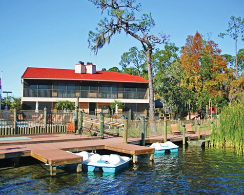 Pathway to units at Bryan's Spanish Cove alongside a lake with paddle boats.