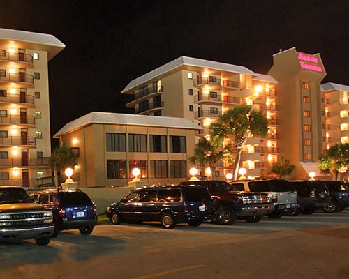 An exterior view of multi story units with parking lot.