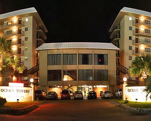 Exterior view of Ocean Towers Beach Club resort at night.
