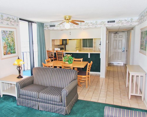 An open plan living room and dining area with a breakfast bar.