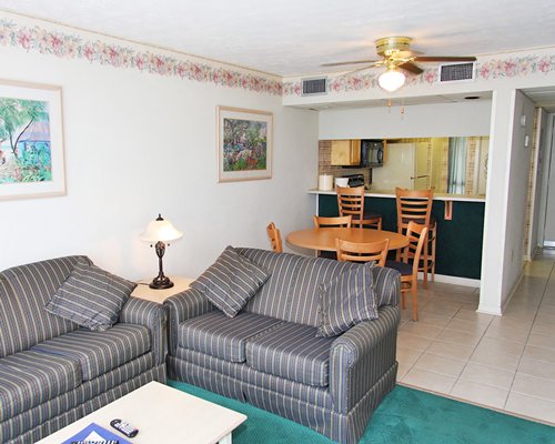 A well furnished living room with open plan kitchen and dining area.
