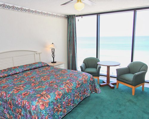 A well furnished bedroom with the beach view.
