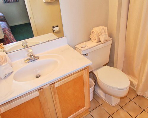 A view of bathroom with a single sink vanity.