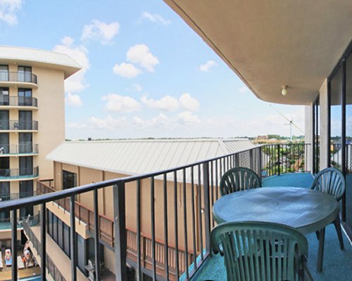 A balcony with patio furniture and an outside view.