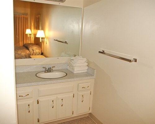 A closed sink vanity alongside the bedroom.