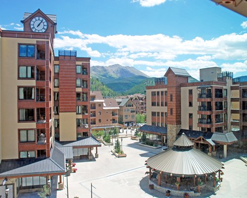 An exterior view of The Village at Breckenridge alongside mountains.