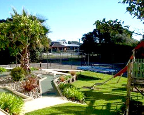 Scenic outdoor kids playscape area with trampoline.