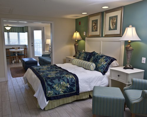 A well furnished bedroom alongside a living room.