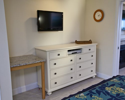 A well furnished bedroom with television.