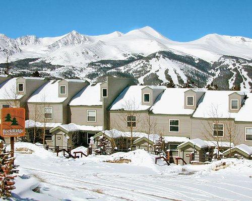 Exterior view of Rockridge I with a signboard alongside mountains covered with snow.