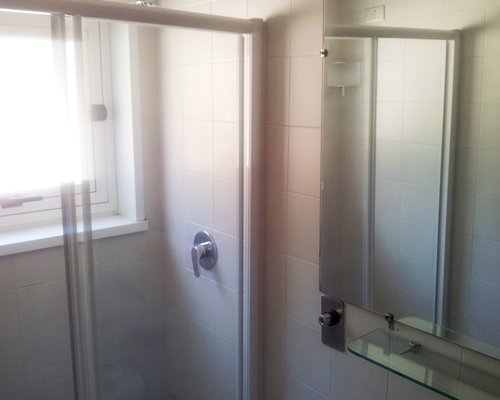 A bathroom with shower stall.
