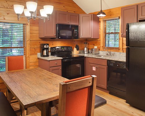 A wood paneled dining and kitchen area.