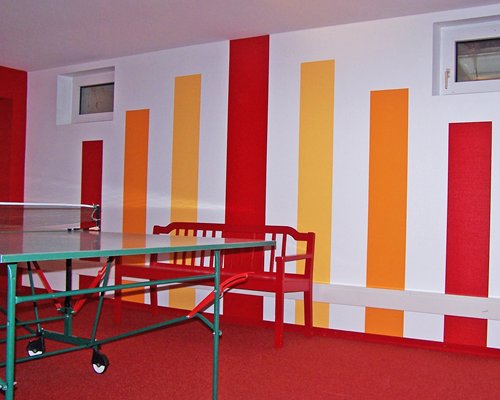 An indoor recreation room with ping pong table.