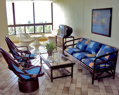A well furnished living room with television and an outside view.