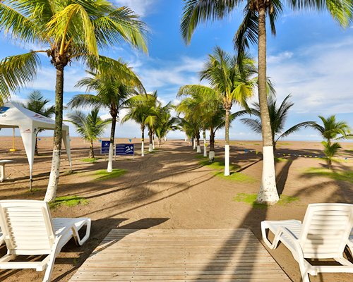 View of the kids play area and volleyball court in the beach alongside the ocean.