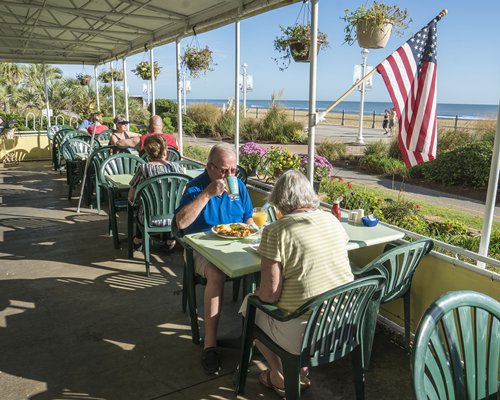 View of people in a restaurant at Four Sails Resort with the ocean view.
