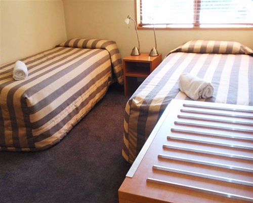 A well furnished bedroom with two beds.