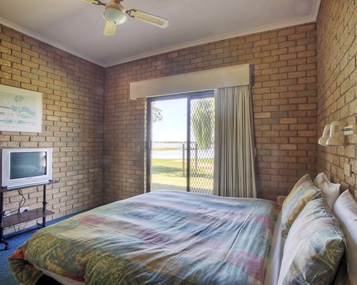 A well furnished bedroom with television.