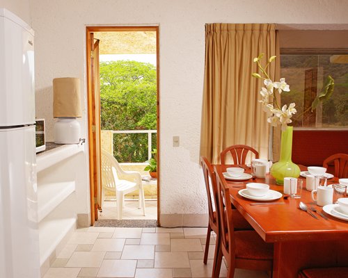 A well furnished dining room with a balcony.