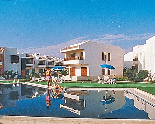 Scenic outdoor swimming pool alongside resort.