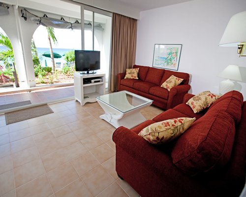 A well furnished living room with a television and patio.