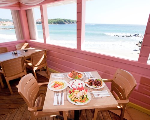 Balcony with a dining area alongside the beach.