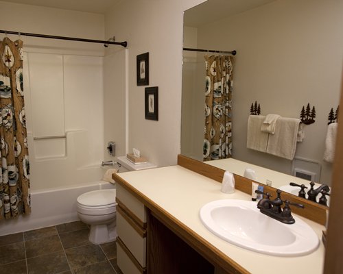 A bathroom with a bathtub and closed sink vanity.