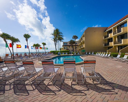 An outdoor swimming pool with chaise lounge chairs alongside the resort unit.