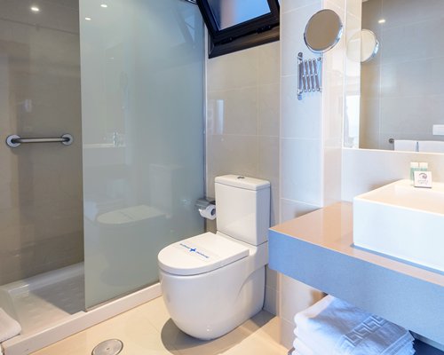 A bathroom with stand up shower.