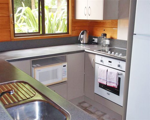 A well equipped kitchen with an outside view.