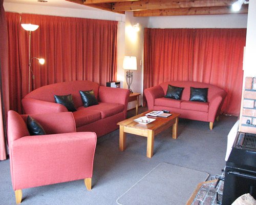 A well furnished living room with double pull out sofas.
