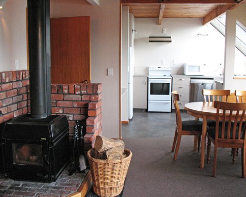 A well equipped kitchen with dining area and fireplace.