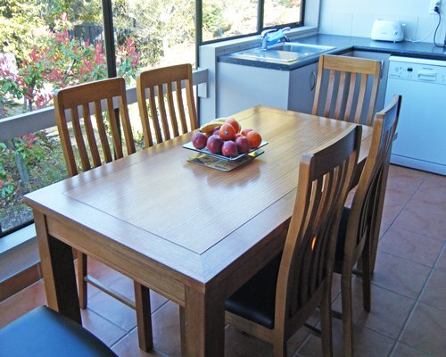 An open plan kitchen with dining area and outside view.
