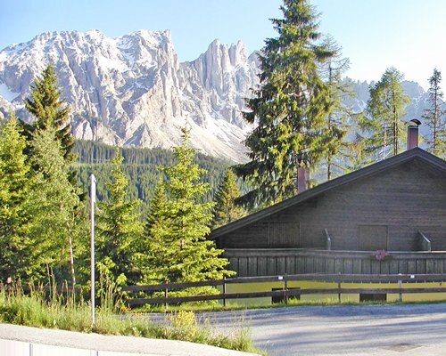 A view of mountains from resort units alongside trees.