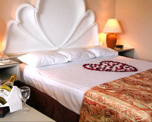 A well furnished bedroom with beverages.