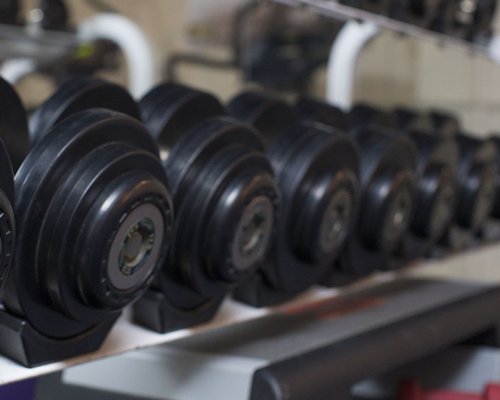 View of dumbbells in a well equipped fitness center.
