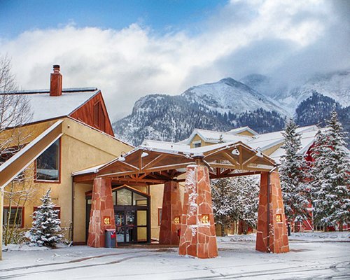 An exterior view of the Village Square At Copper Mountain Resort covered in snow.