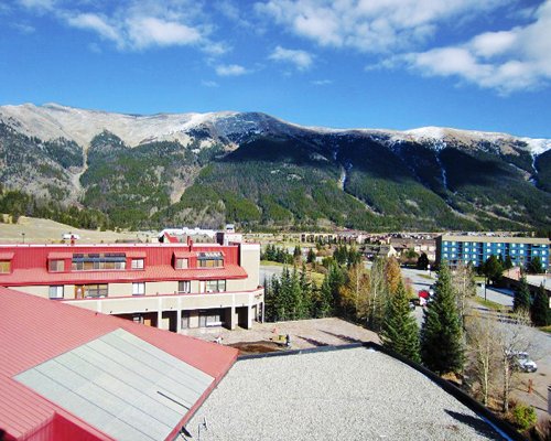 Exterior view of Village Square At Copper Mountain Resort surrounded by wooded area.