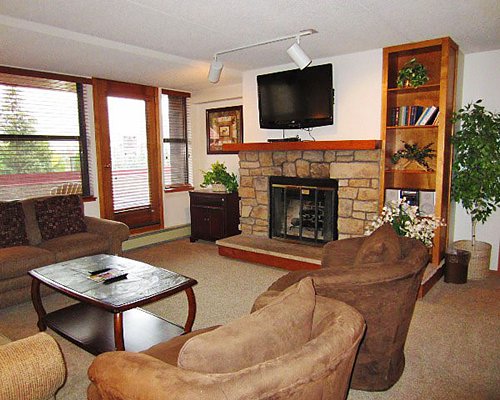 A well furnished living room with a television fireplace and balcony.