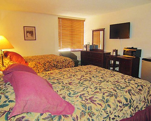 A well furnished bedroom with television.