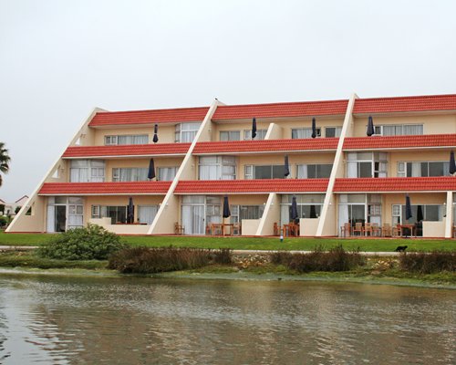 Scenic exterior view of the multi story resort alongside the waterfront.