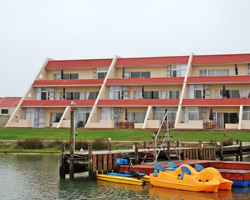 A marina on the waterfront alongside the multi story units.