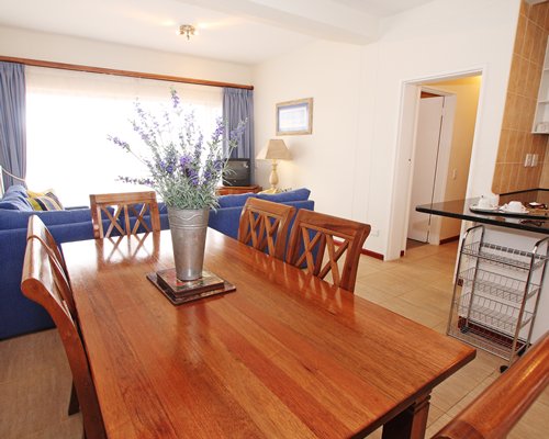 A well furnished living and dining area with a television.